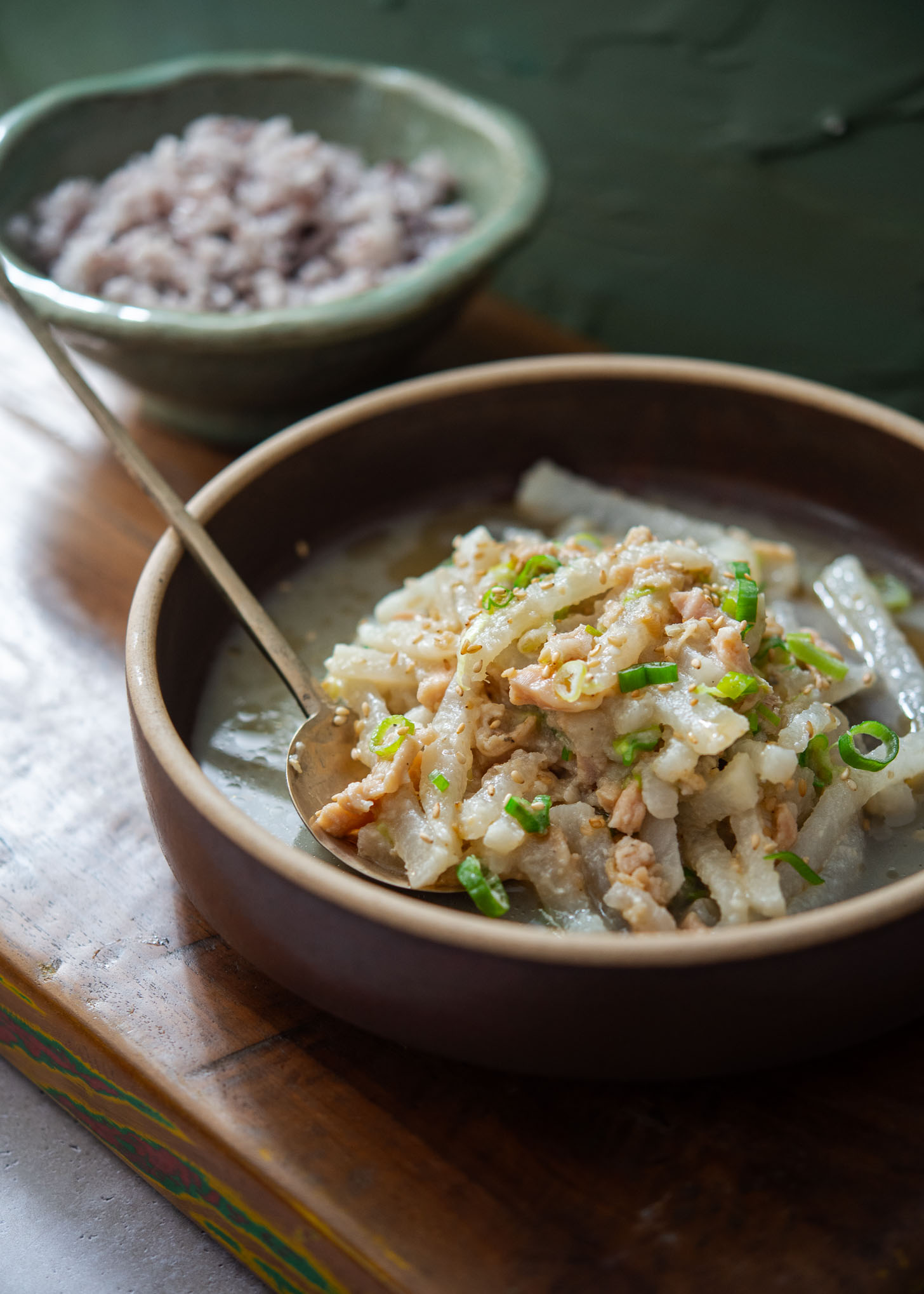 A bowl of Korean radish and clams served with rice.