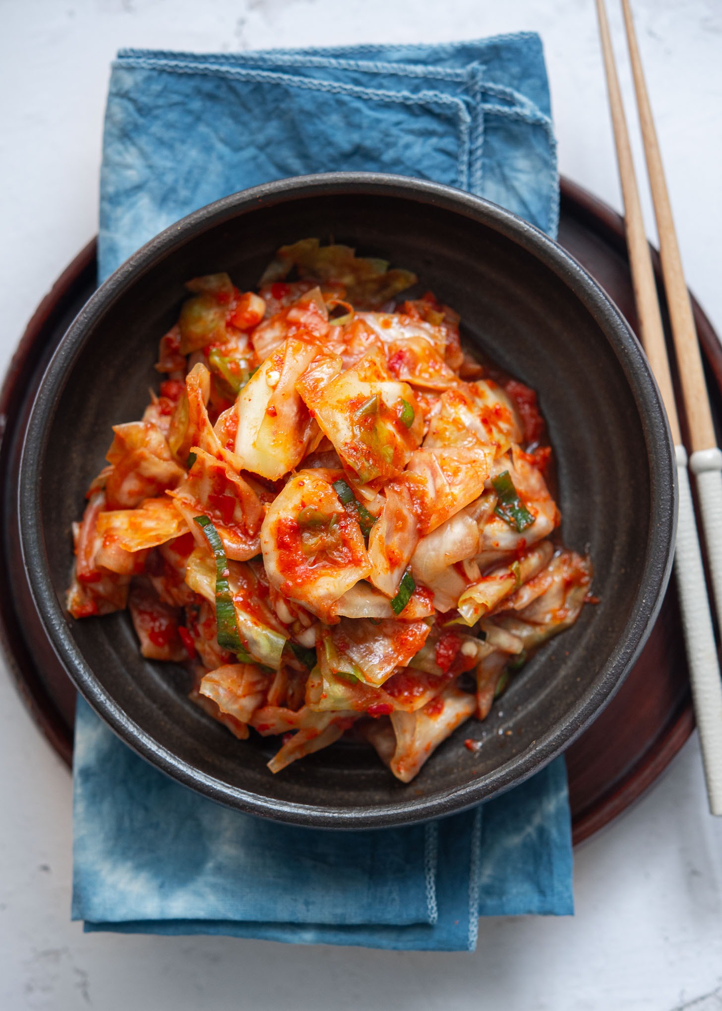 Green cabbage kimchi in a serving dish.