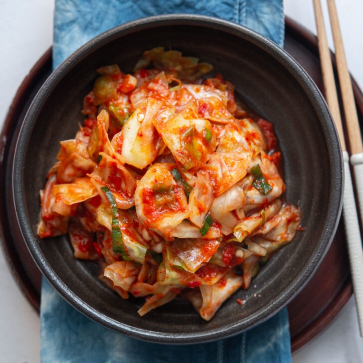 Green cabbage kimchi in a serving dish.
