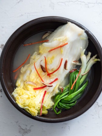 White kimchi in a serving bowl.