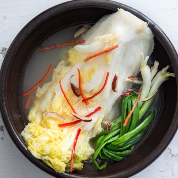 White kimchi in a serving bowl.