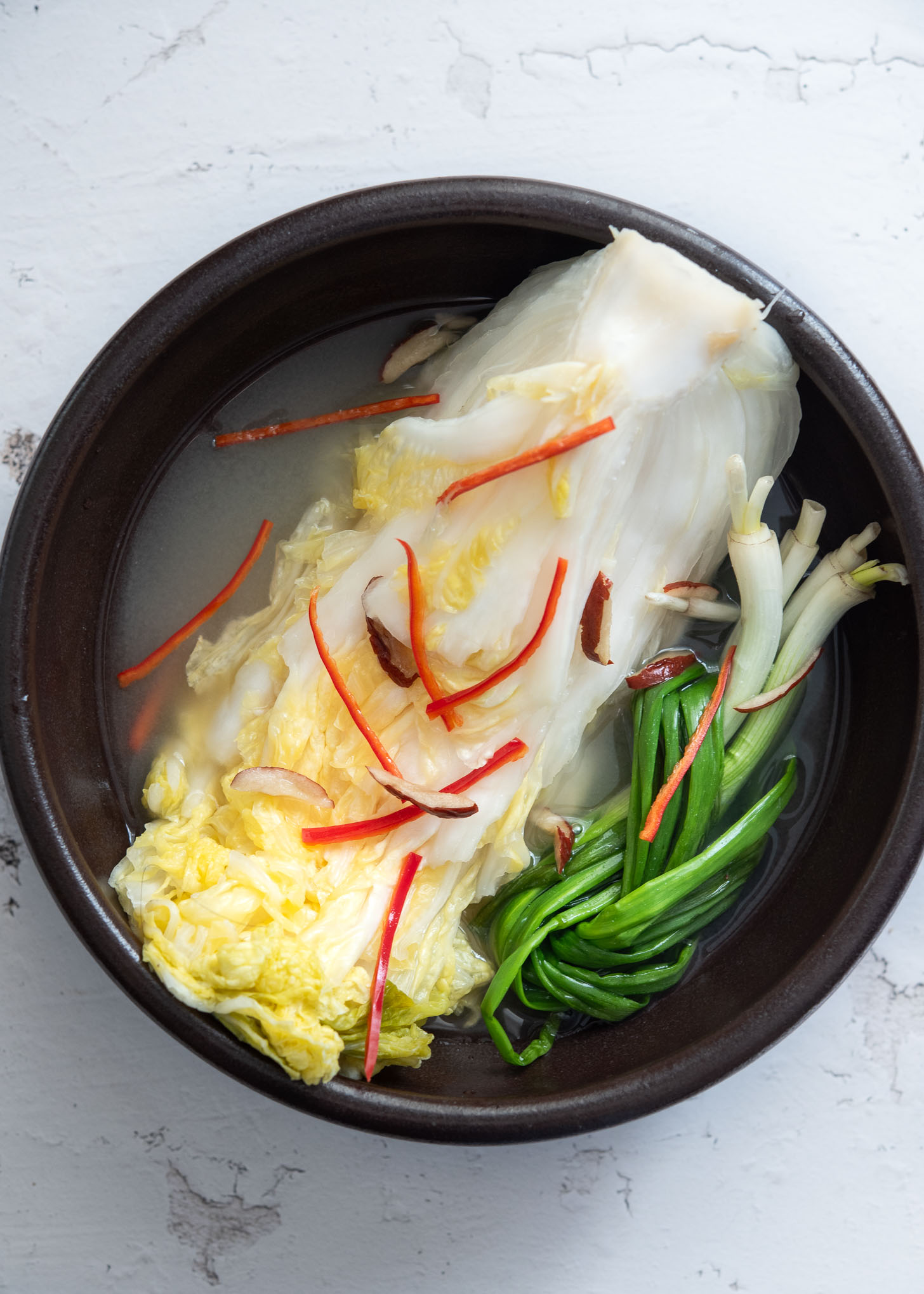 White kimchi (baek kimchi) in a serving bowl.