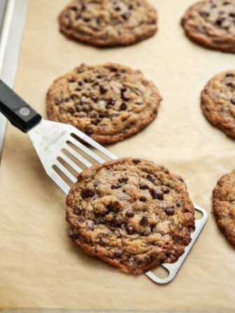 Toffee chocolate chip cookies on a baking sheet.