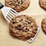 Toffee chocolate chip cookies on a baking sheet.