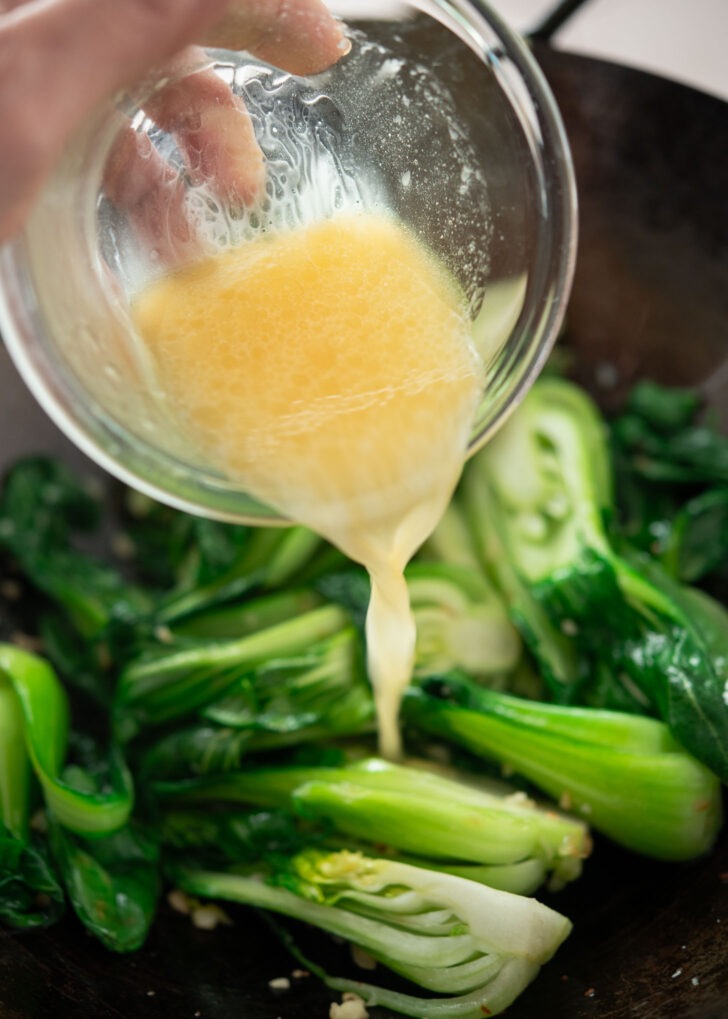Savory sauce mixture poured over stir-fried bok choy.