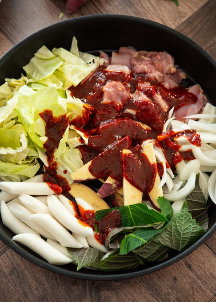 Dakgalbi sauce drizzled over chicken and vegetables.