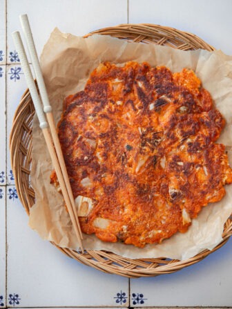 Crispy kimchi pancake (kimchi jeon) on a serving platter.