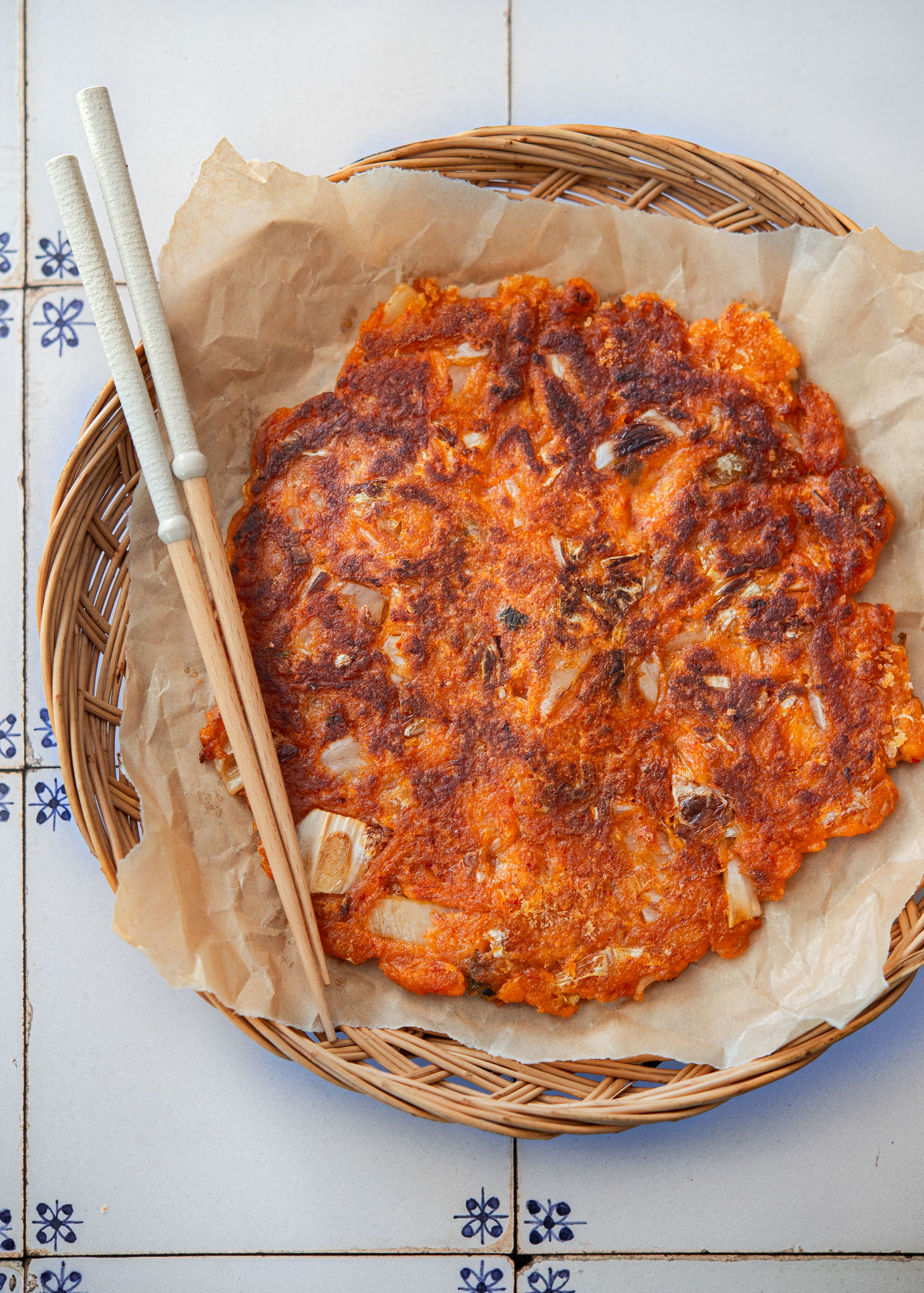 Crispy kimchi pancake (kimchi jeon) on a serving platter.
