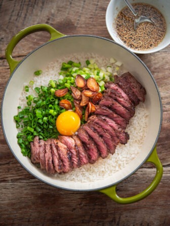 Korean pot rice with grilled steak served in a pot.