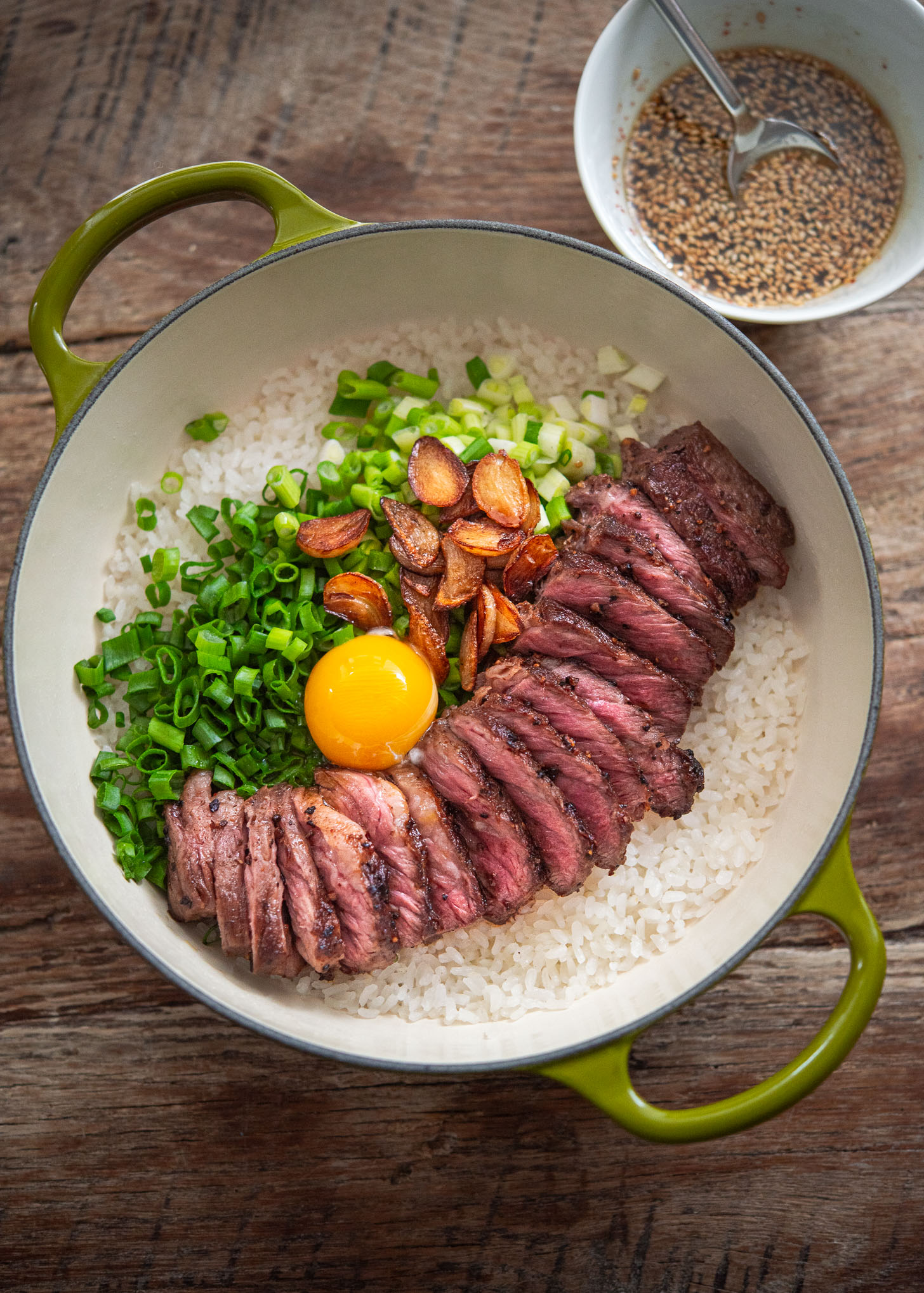 Korean pot rice with grilled steak served in a pot.