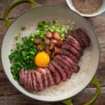 Korean pot rice with grilled steak served in a pot.