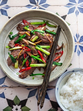 Ginger beef stir-fry plated with steamed rice for a quick and easy Asian dinner.
