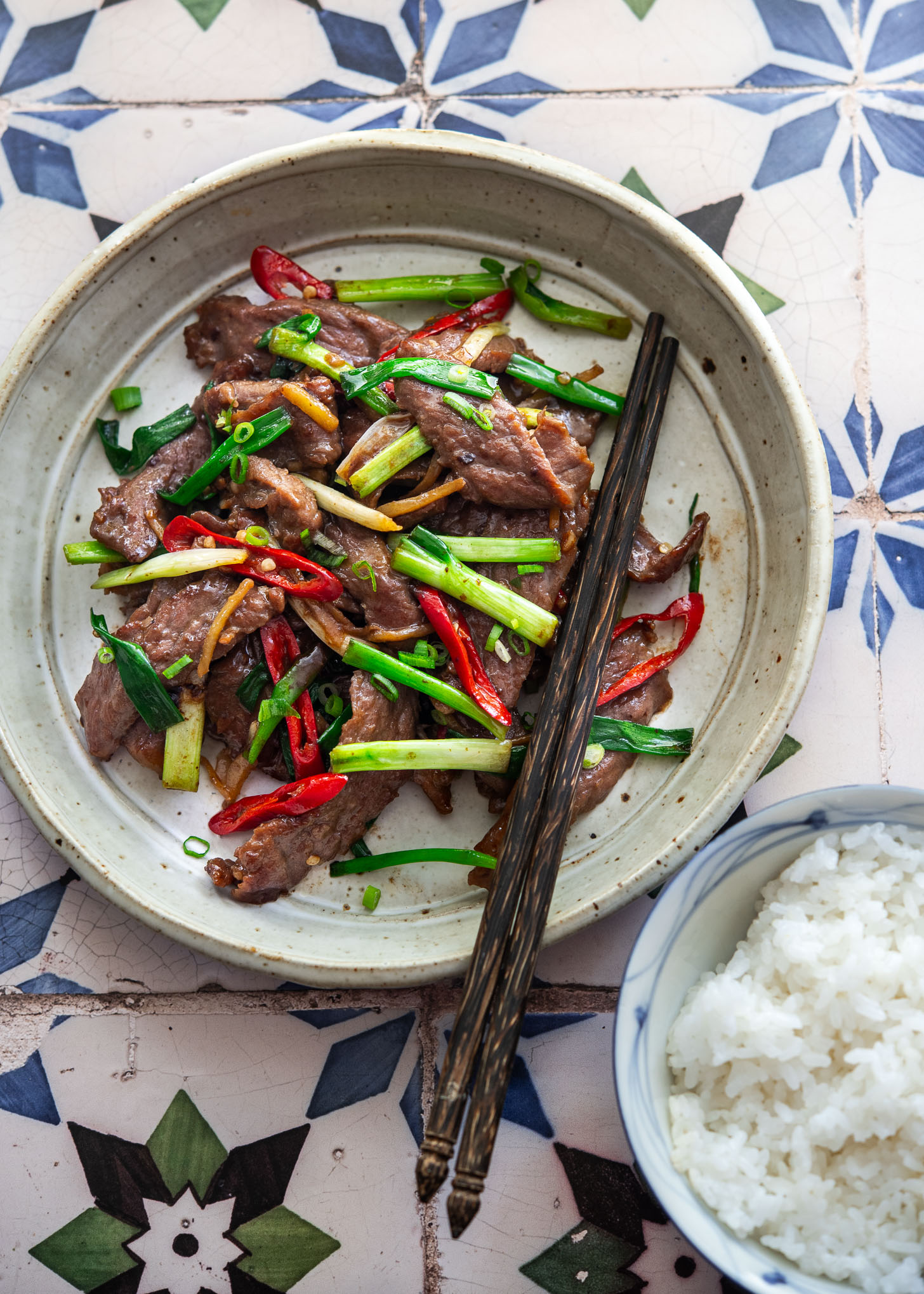 Ginger beef stir-fry plated with steamed rice for a quick and easy Asian dinner.
