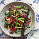 Ginger beef stir-fry plated with steamed rice for a quick and easy Asian dinner.