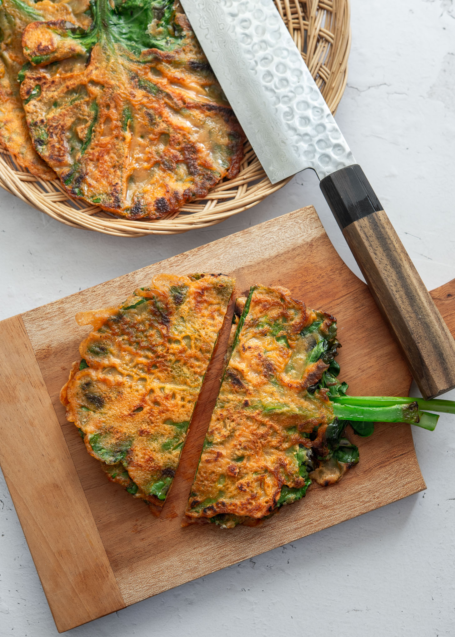 Kale gochujang pancake (jangtteok) cut in half and ready to serve