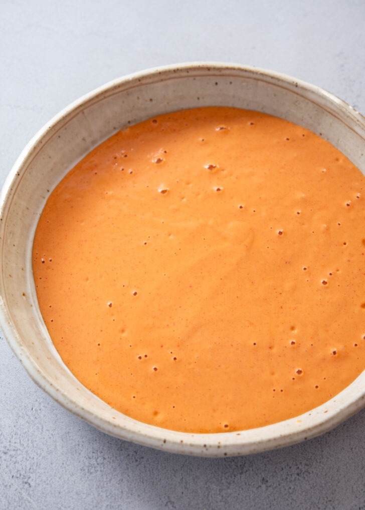 Gochujang pancake (jangtteok) batter poured into a shallow bowl, ready for dipping