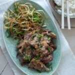 Korean doenjang pork (maekjeok) served with green onion salad and rice.