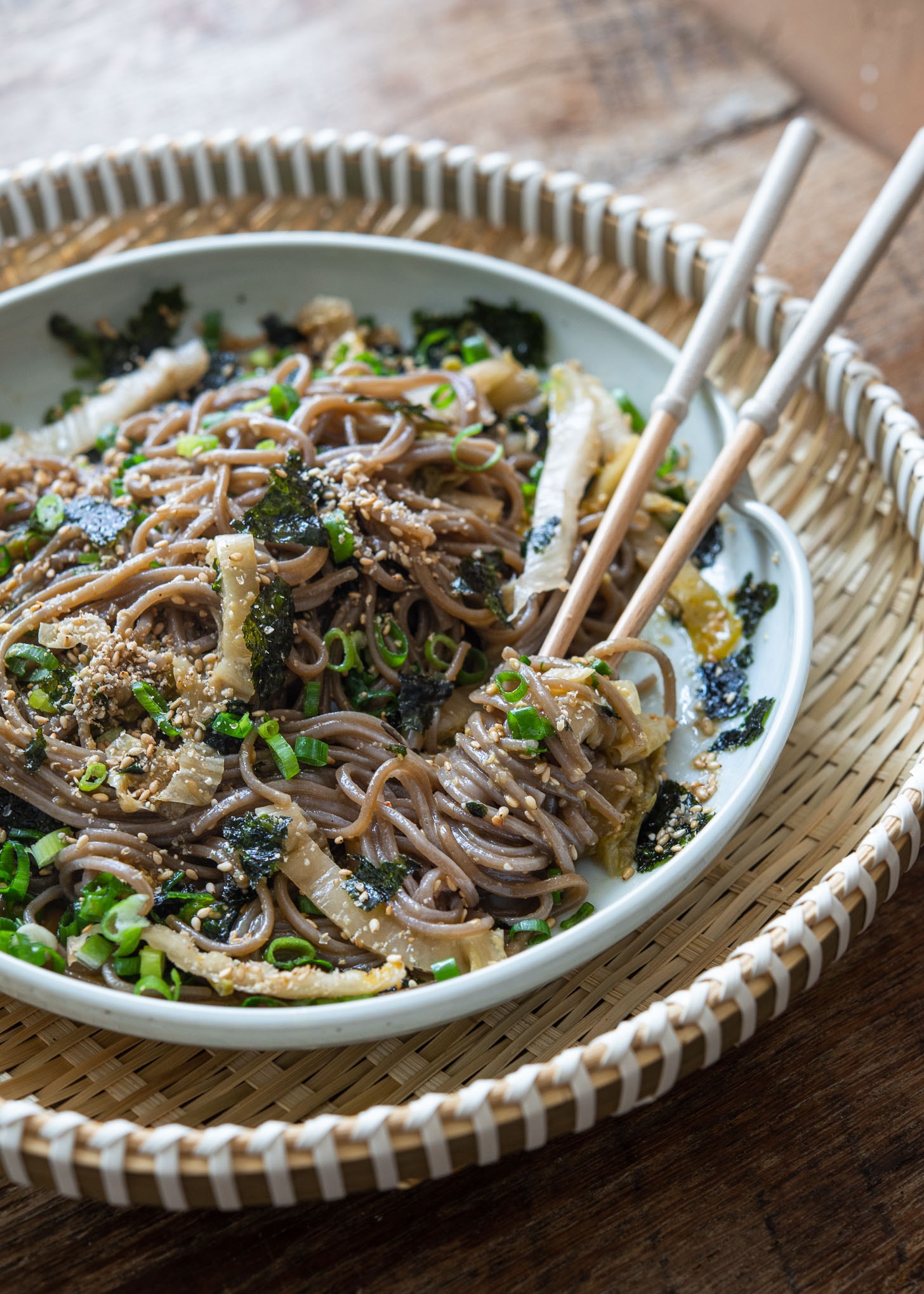A pair of chopsticks twirling the makguksu noodles