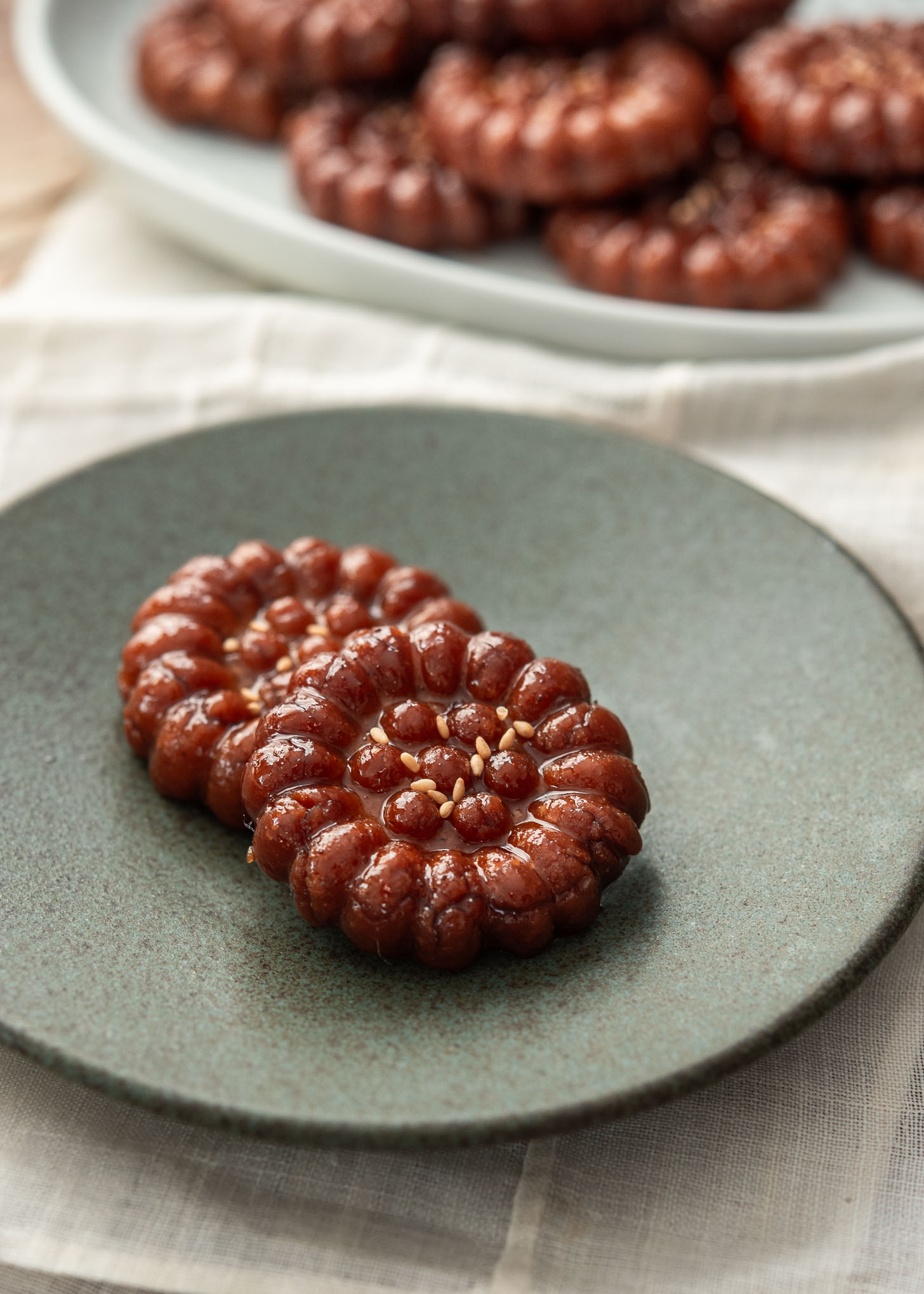 Two yakgwa ,Korean honey cookies, on a serving plate