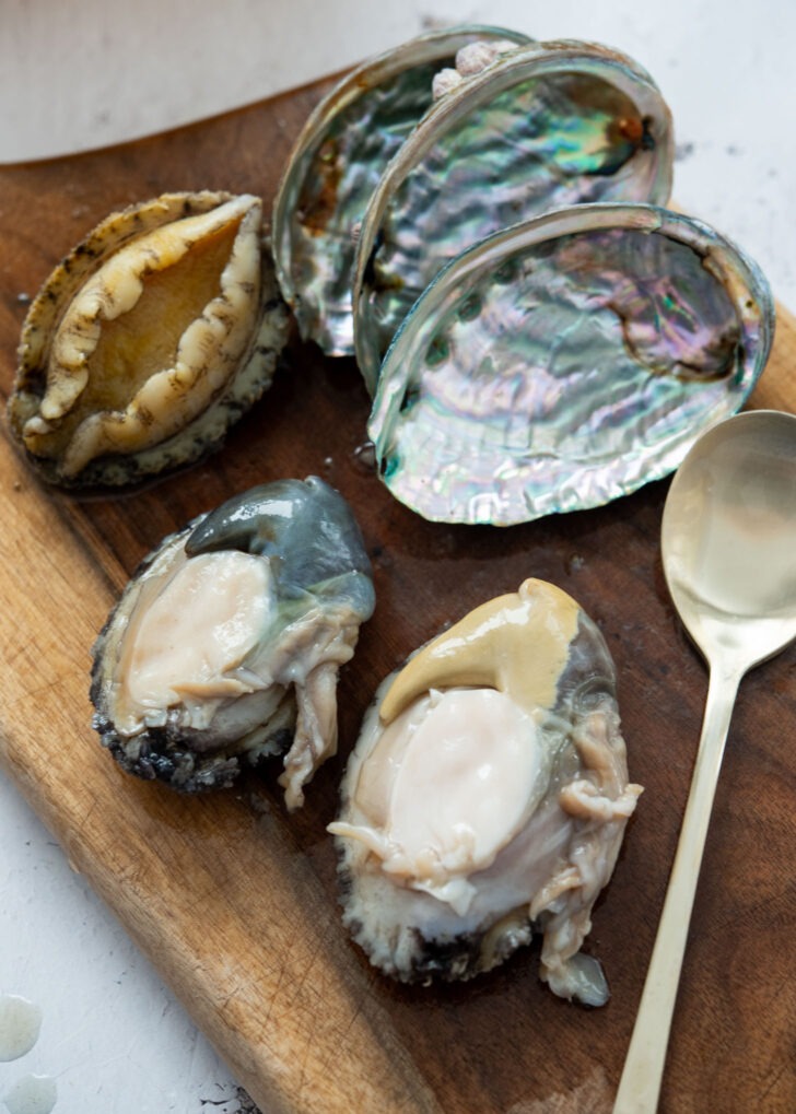 Cleaned fresh abalone and empty shells on board