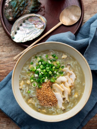 Korean abalone porridge topped with green onion and sesame