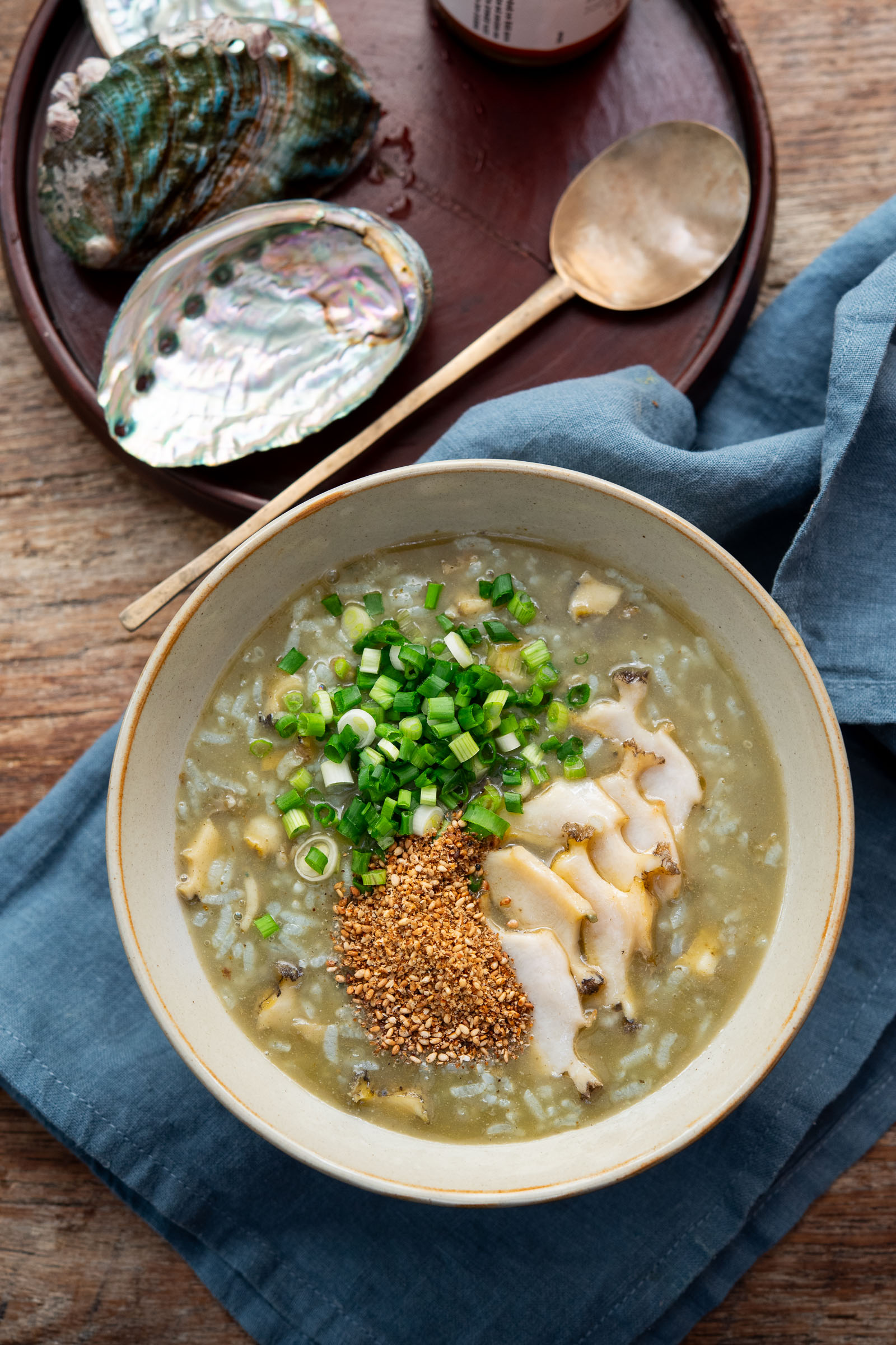 Korean abalone porridge topped with green onion and sesame