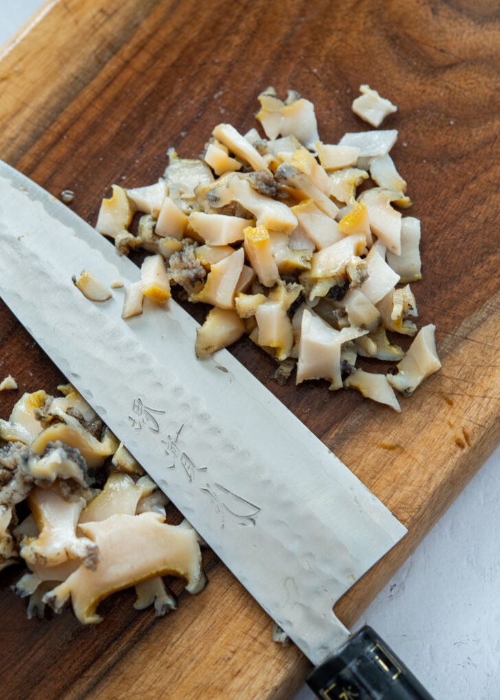 Chopping fresh abalone for Korean abalone porridge