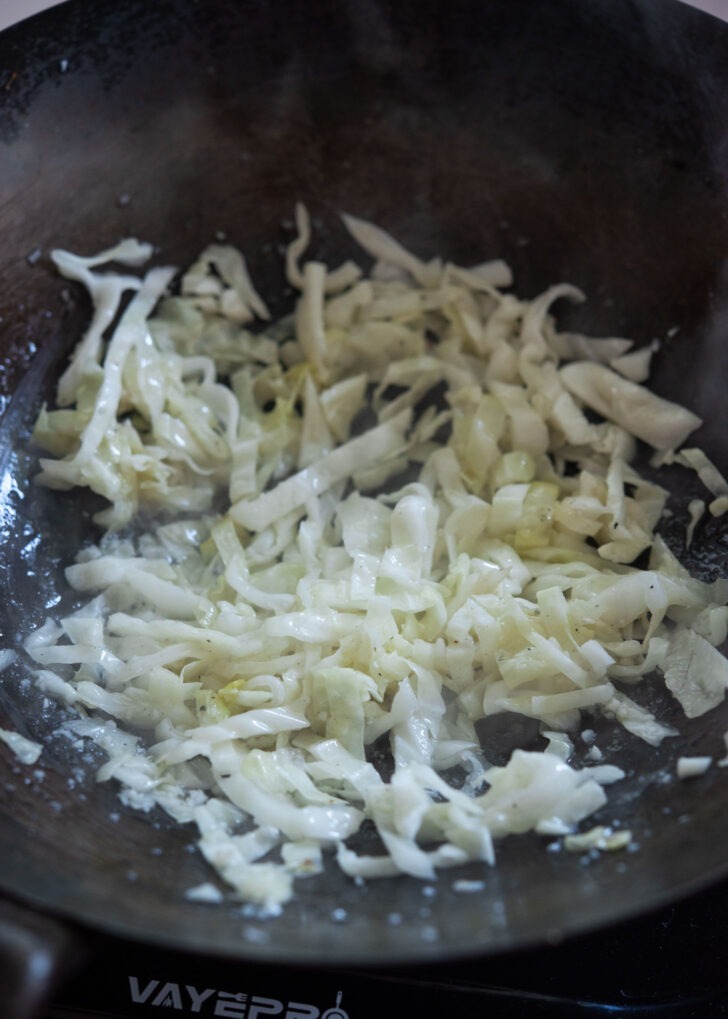 Cabbage slices frying in oil