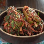 Stuffed cucumber kimchi (oi sobagi) made with cucumbers, garlic chives, and Korean chili flakes