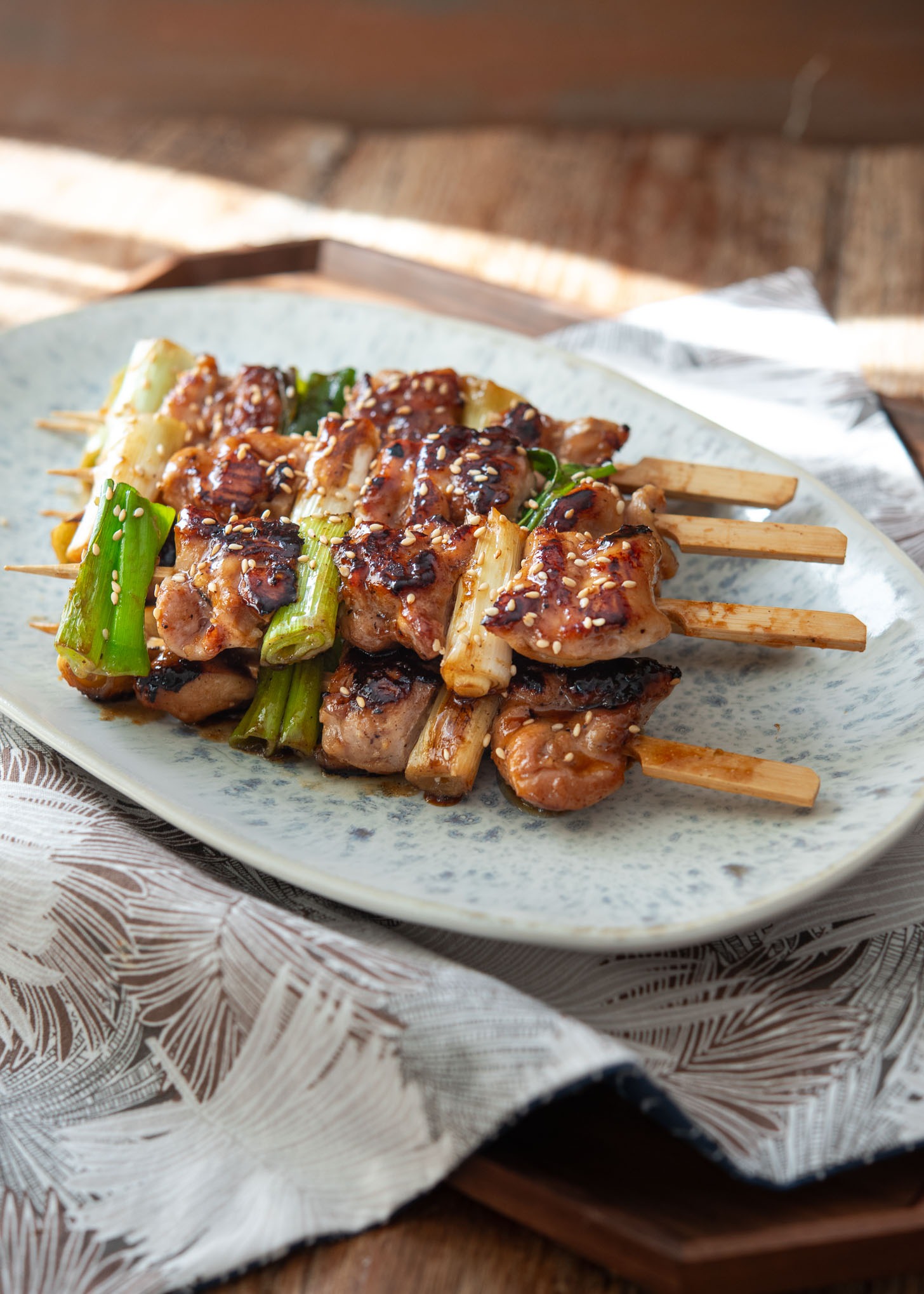 Plated Korean chicken skewers with glossy caramelized glaze