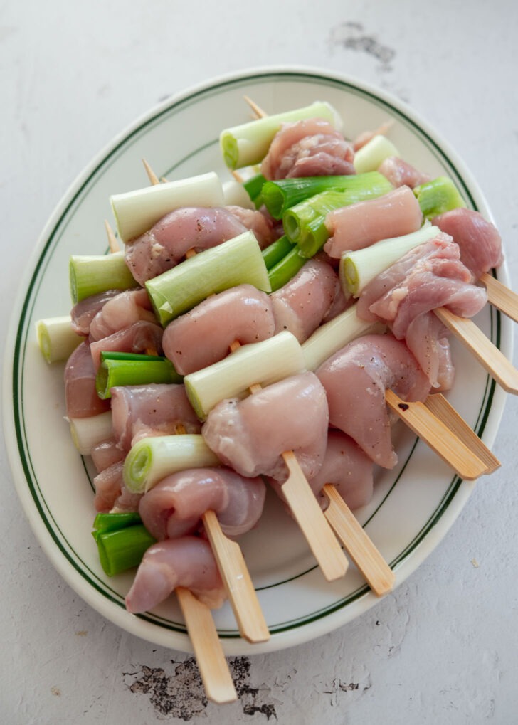 Korean chicken skewers with daepa arranged on a plate