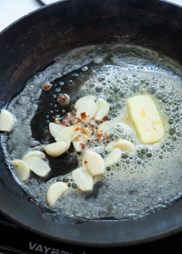 Garlic and chili flakes sizzling in melted butter