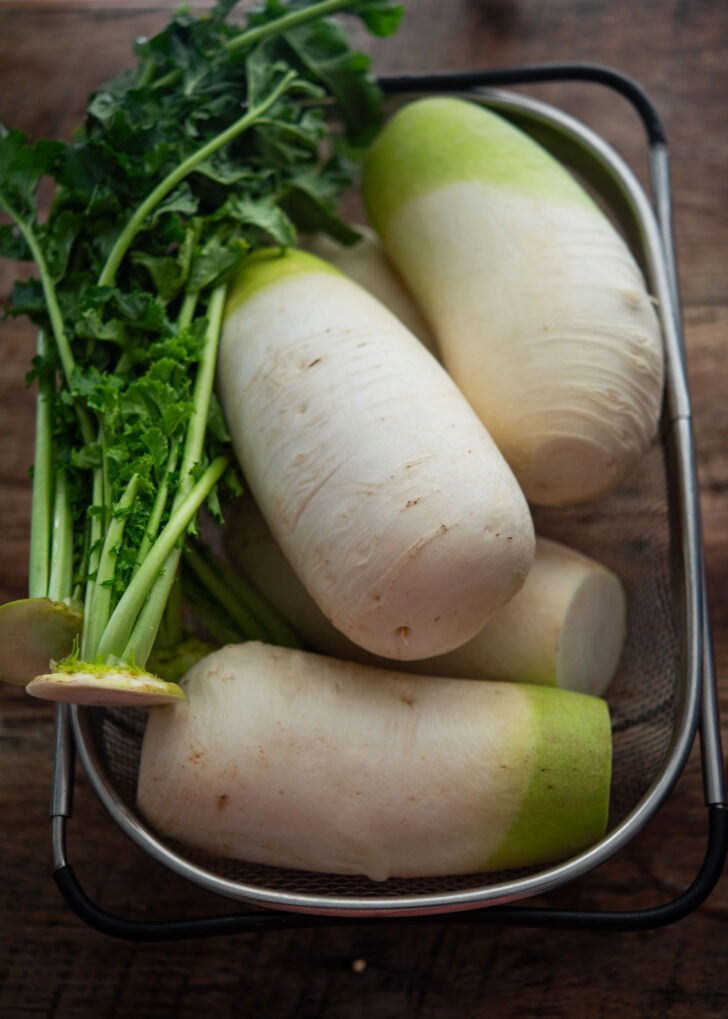Cleaned radishes and greens in a colander