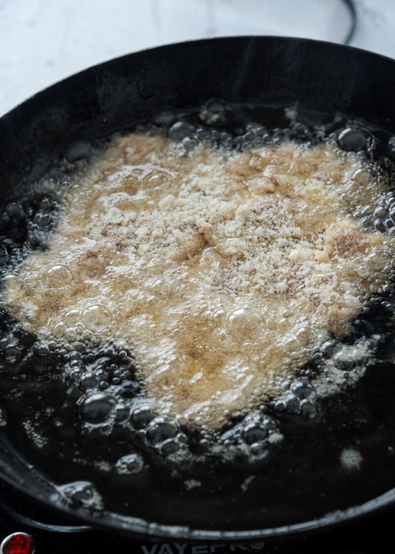Breaded Korean donkatsu pork cutlet frying in hot oil