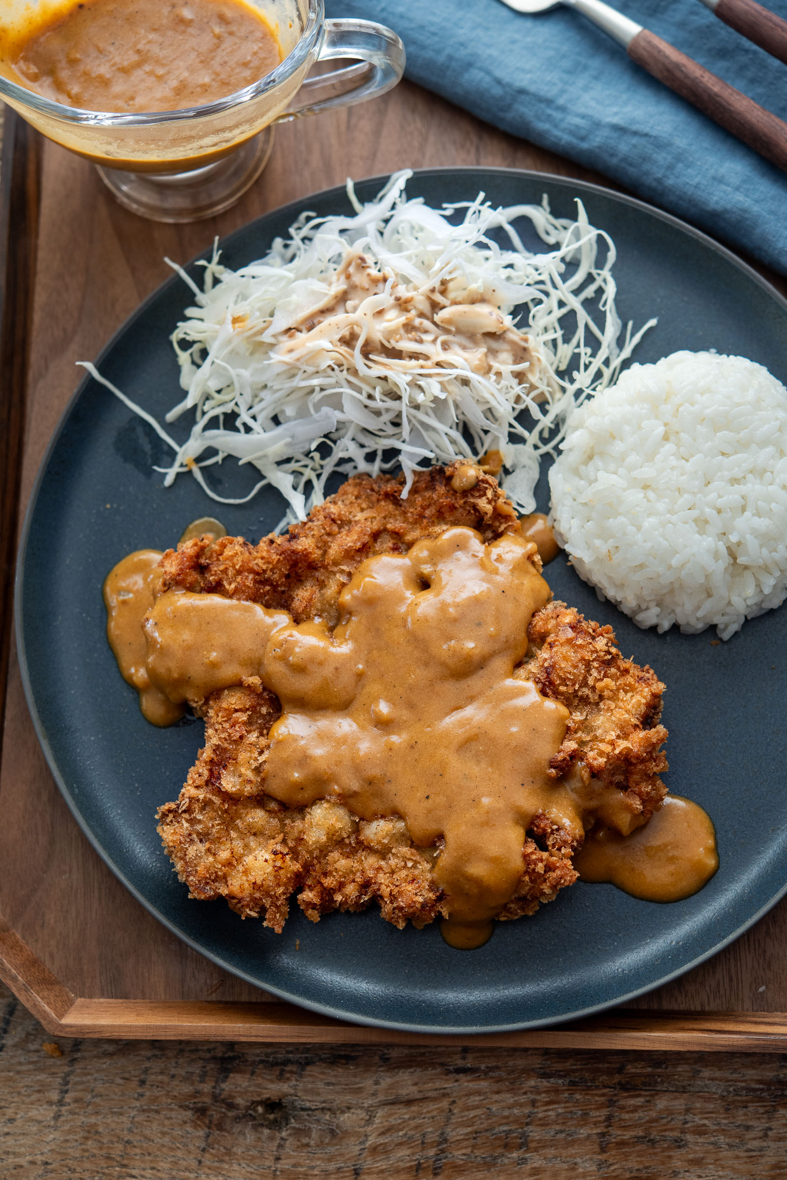 Korean donkatsu pork cutlet with brown sauce, rice, and shredded cabbage