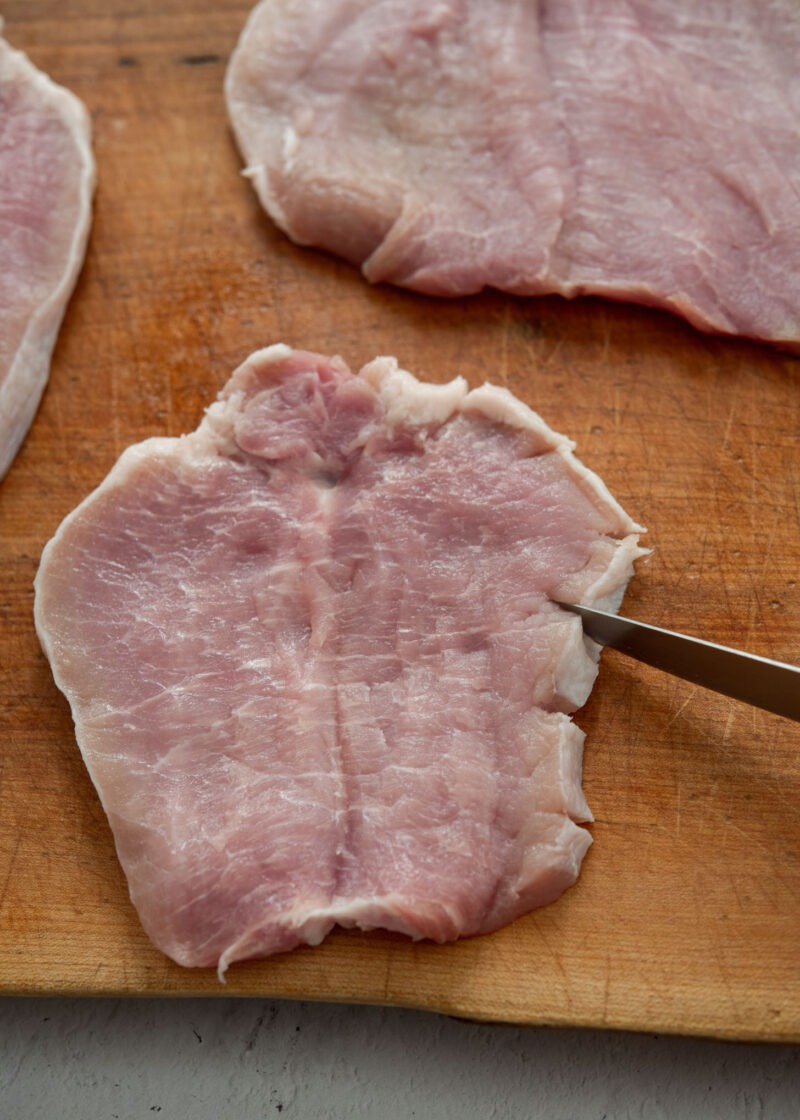 Scoring thin pork loin cutlet before making Korean donkatsu