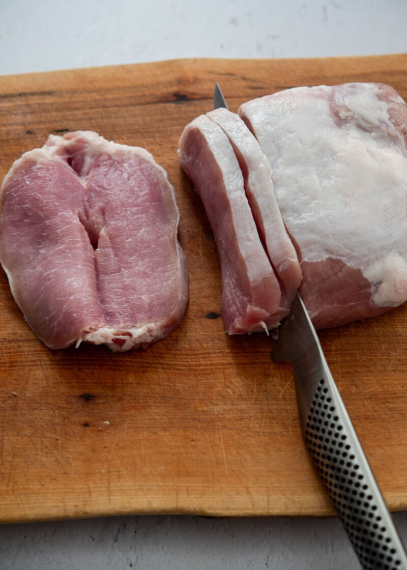 Pork loin being sliced for thin Korean donkatsu cutlets