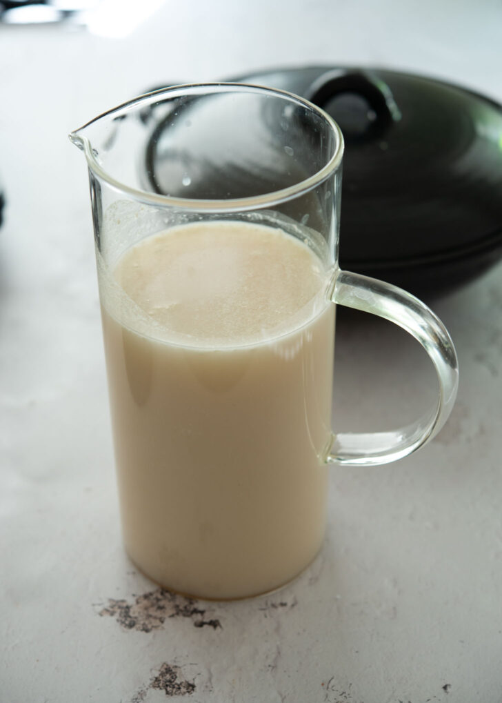 Bone marrow soup base in a jug