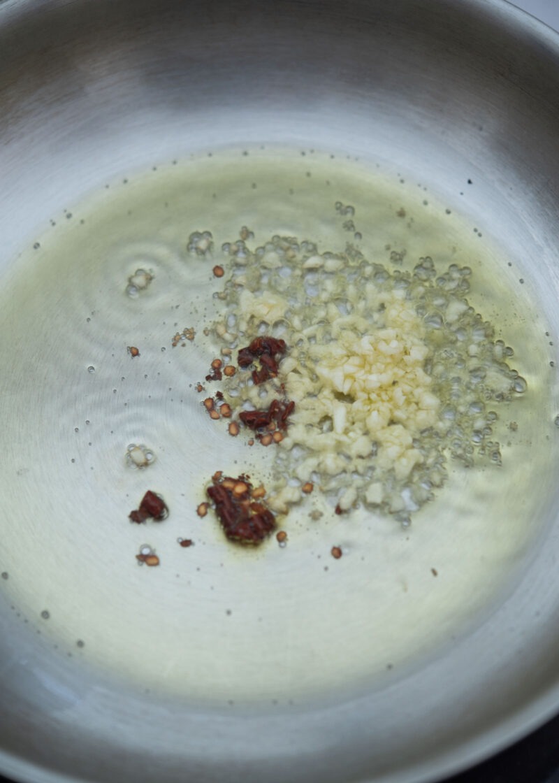 Garlic and chili flakes gently sizzling in oil for pasta base