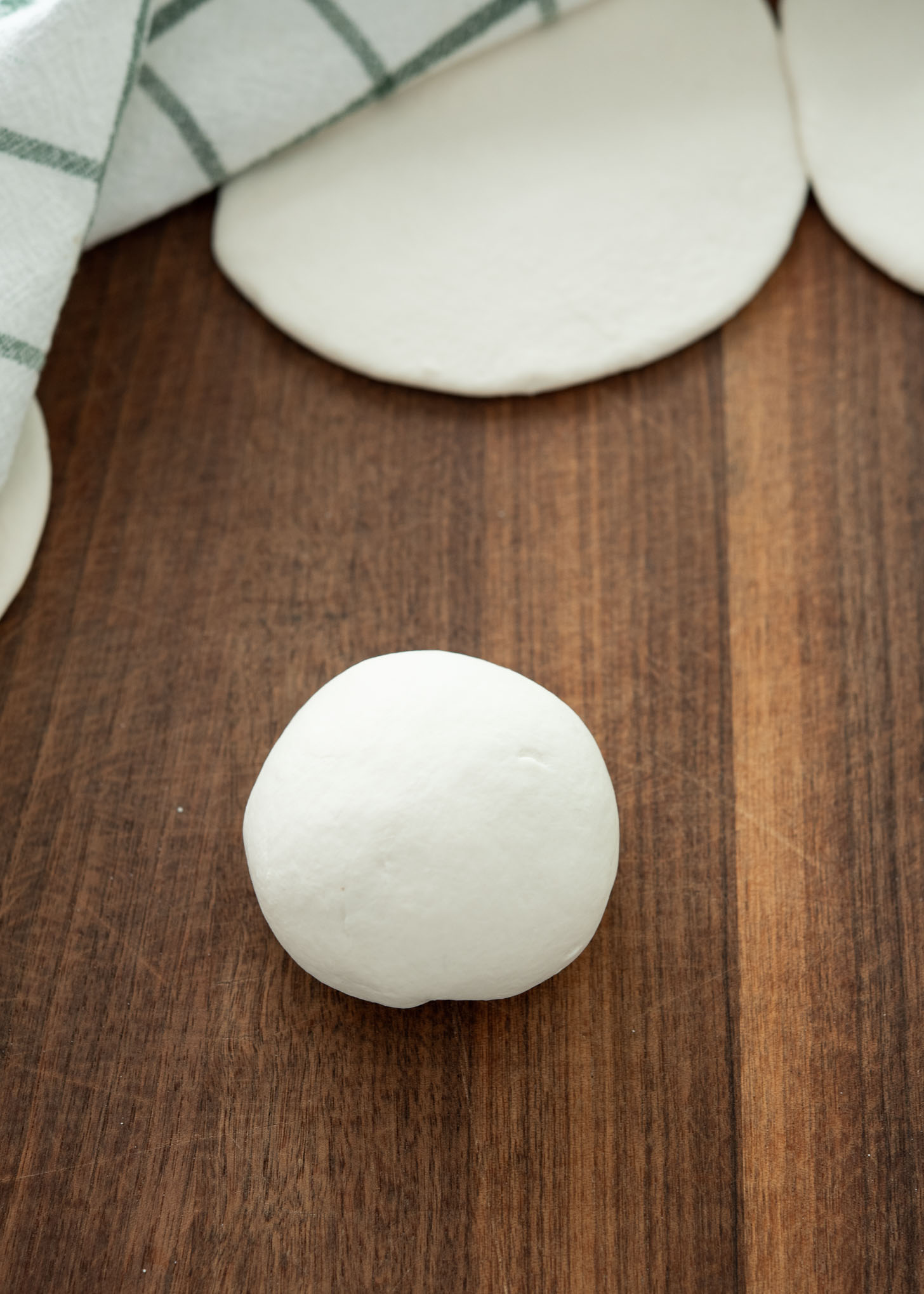 Shaping the hoppang bun into a smooth, rounded shape