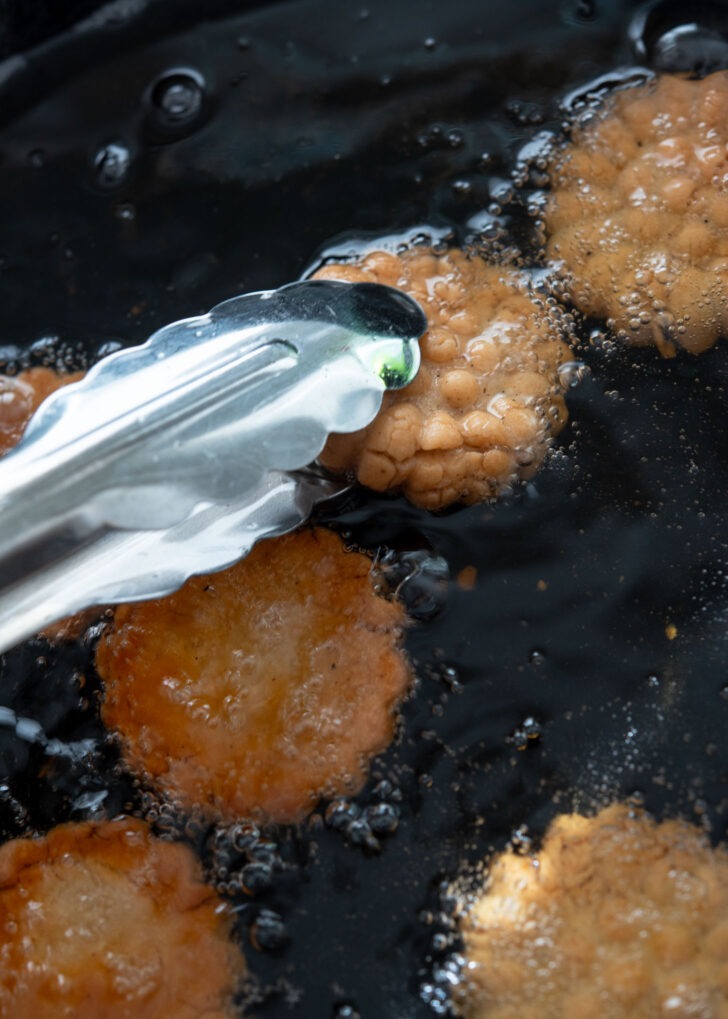 Flipping the cookies to fry the other side