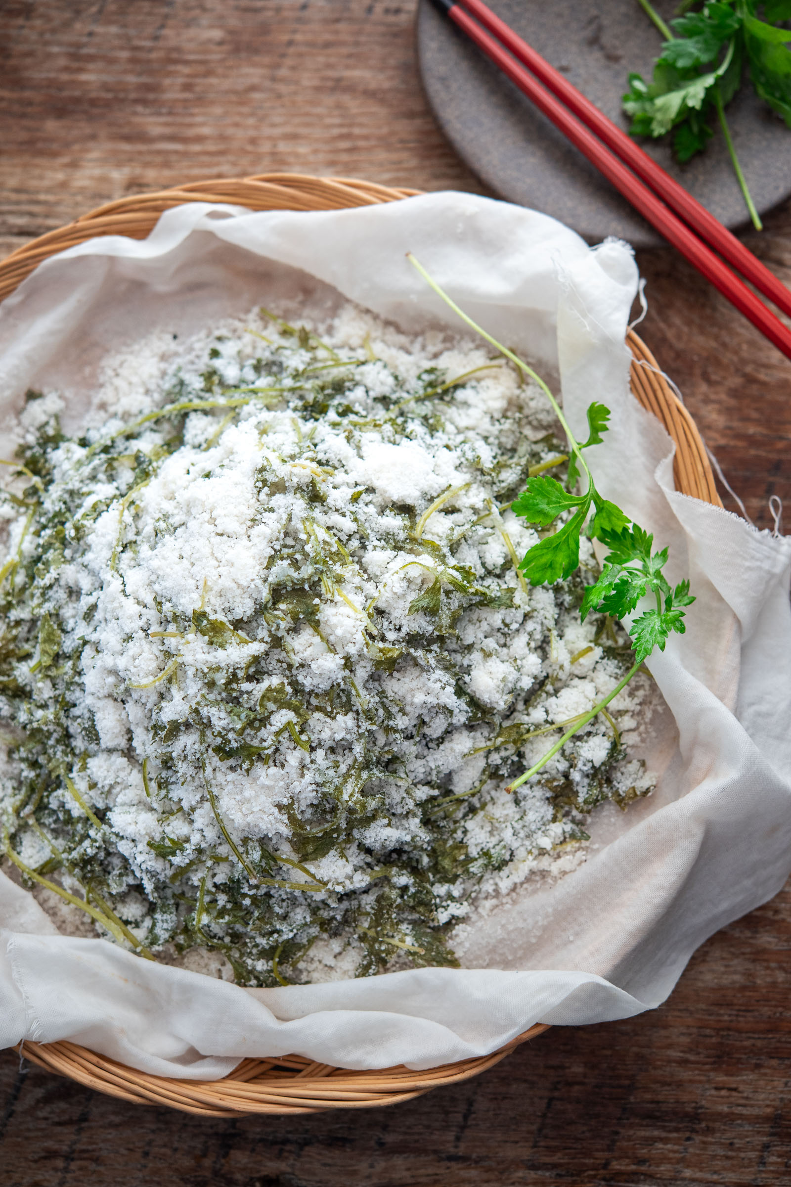 Freshly steamed ssuk beomuri mugwort rice cake in a cloth-lined steamer basket