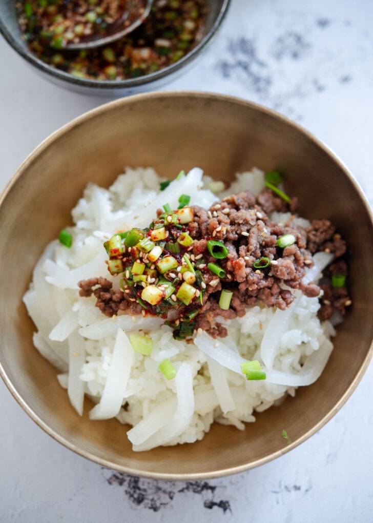 Korean radish rice bowl topped with ground beef bulgogi and sauce