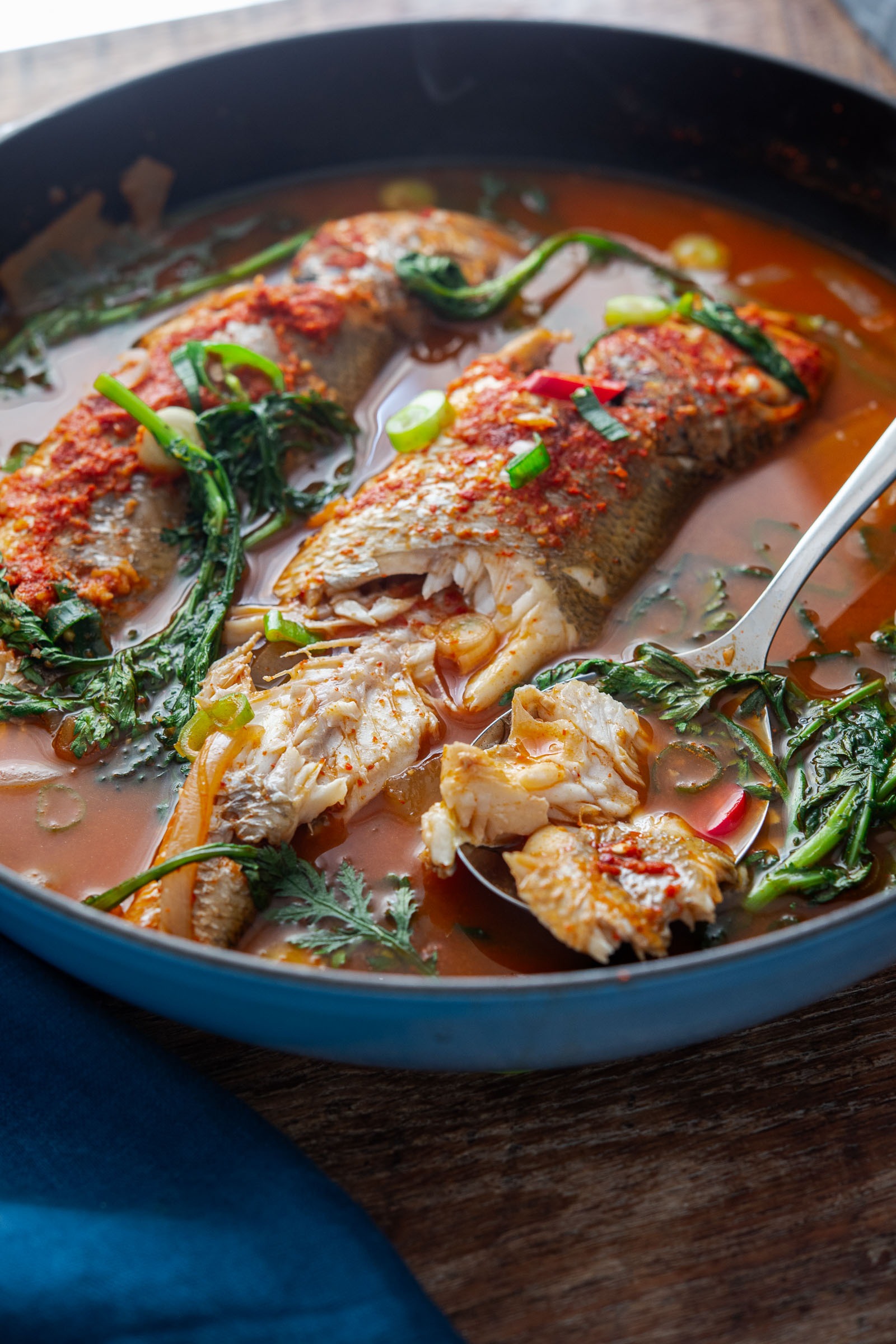 Korean maeuntang fish stew with croaker served in spicy broth with greens