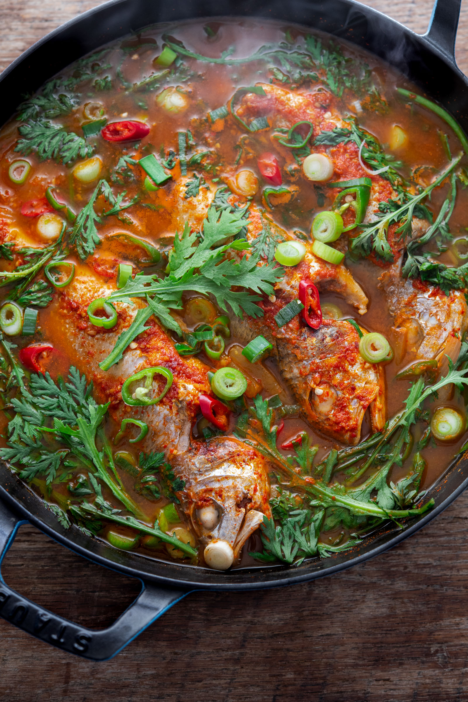 Spicy Korean fish stew (maeuntang) with croaker and fresh herbs