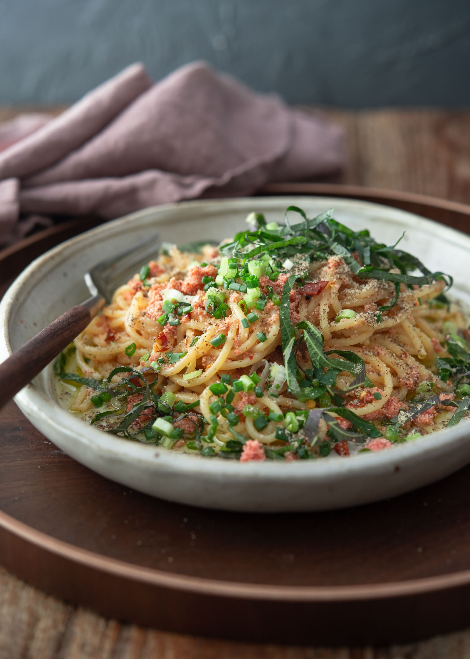 Mentaiko pasta topped with green onion and perilla leaves