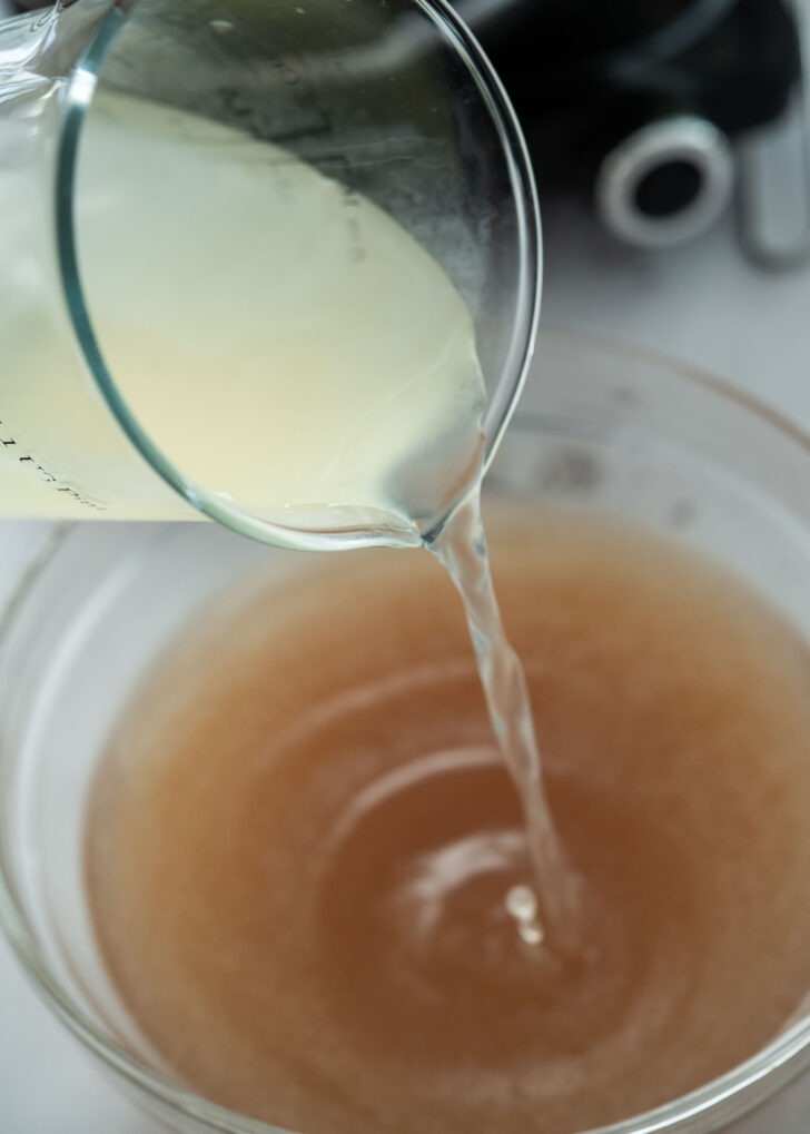 Adding dongchimi water to the naengmyeon beef stock