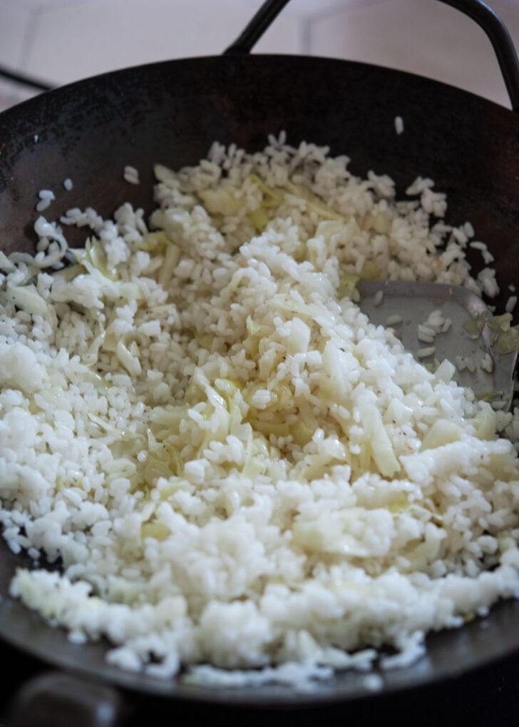 Day old rice added to cabbage to fry together