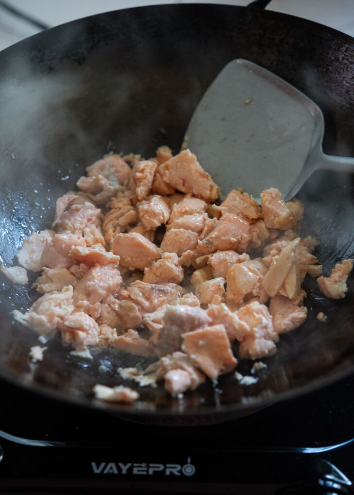 Salmon pieces cooking in a wok