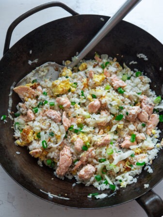 salmon fried rice with egg and cabbage finished cooking in a wok